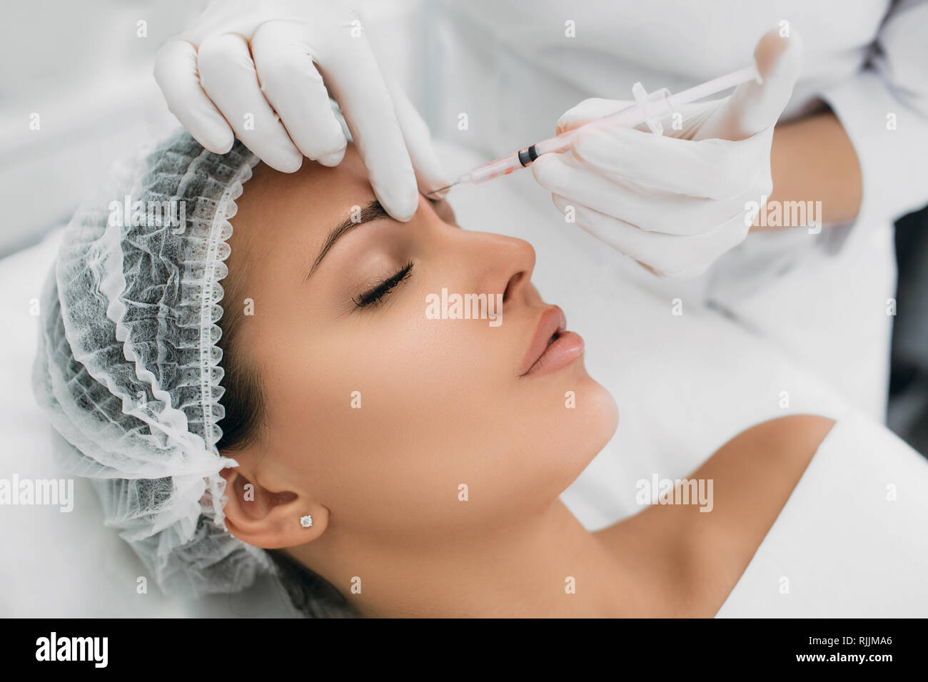 woman receiving injection on face, mesotherapy procedure Stock Photo