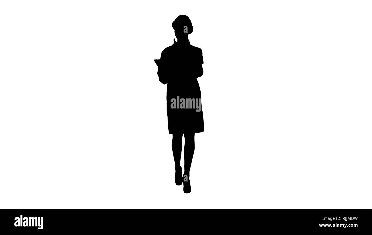 Silhouette Woman engineer checking information and objects on her tablet. Stock Photo