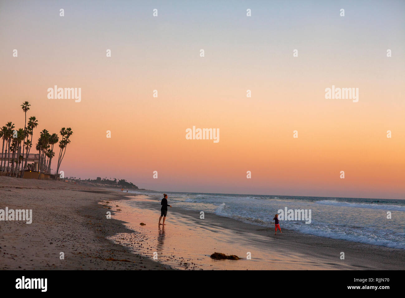 Mother and daughter walking San Clemente State Beach at Dusk Stock Photo