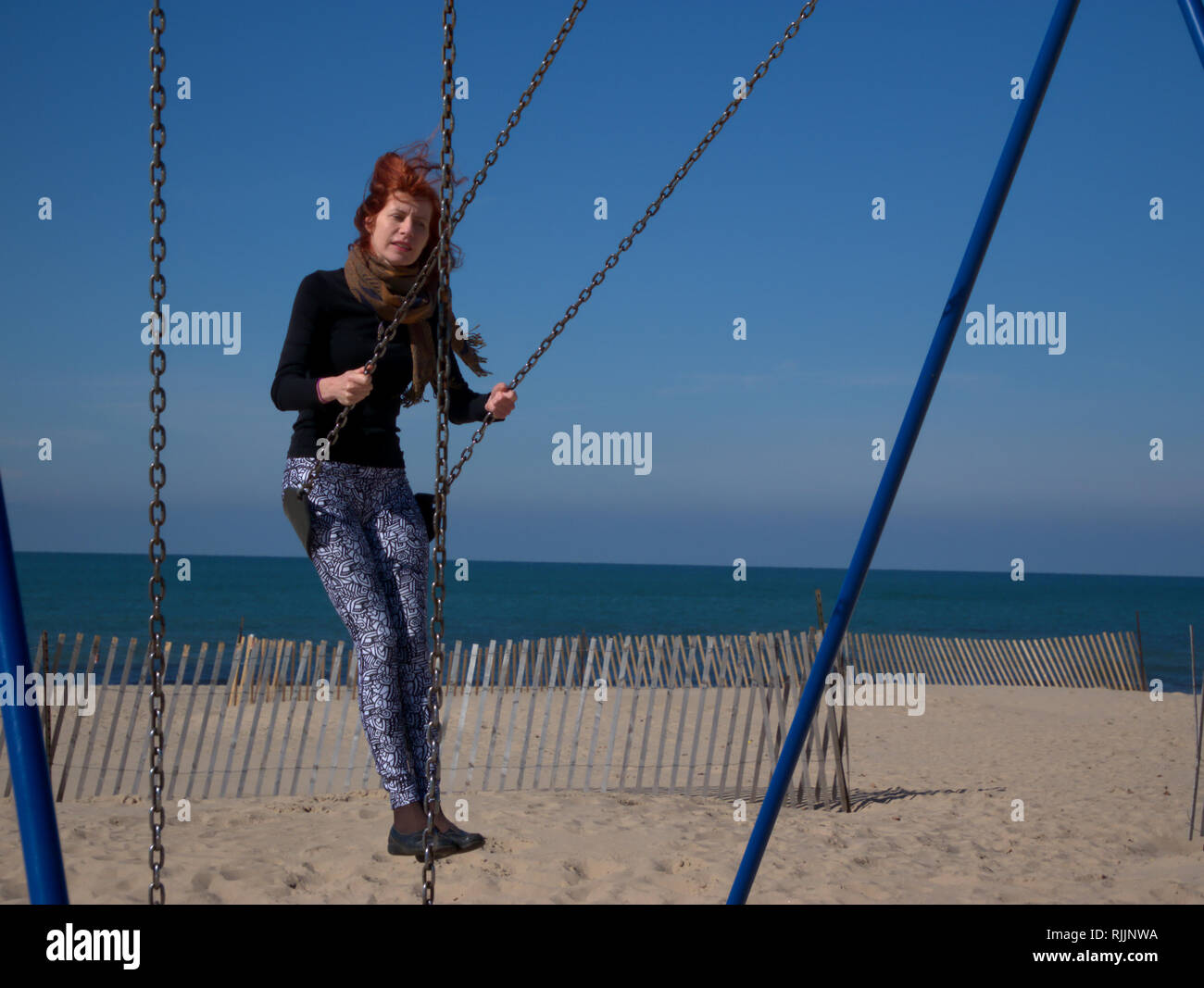 Woman on beach and swing hi-res stock photography and images - Alamy