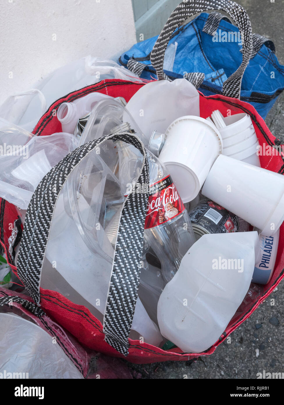 Domestic plastics recycling bag outside house in Cornwall. Rubbish