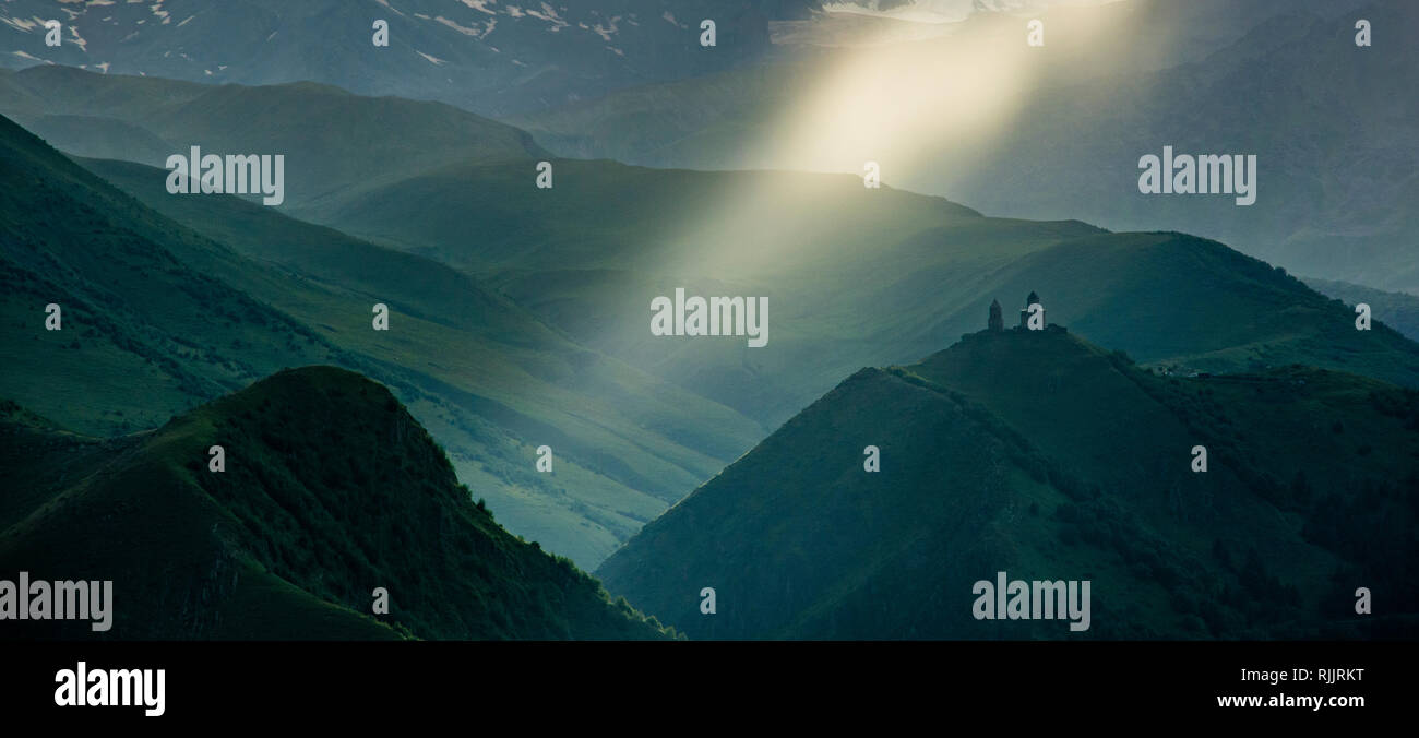 Famous Gergeti Trinity Church near Stepantsminda, Georgia, Caucasus. Stock Photo