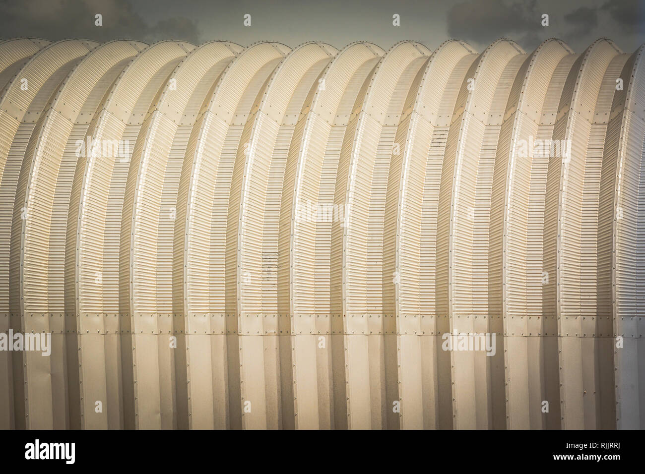 A conceptual background and artistic feeling to a close-up of a half round metal agricultural building outside of Amarillo TX Stock Photo