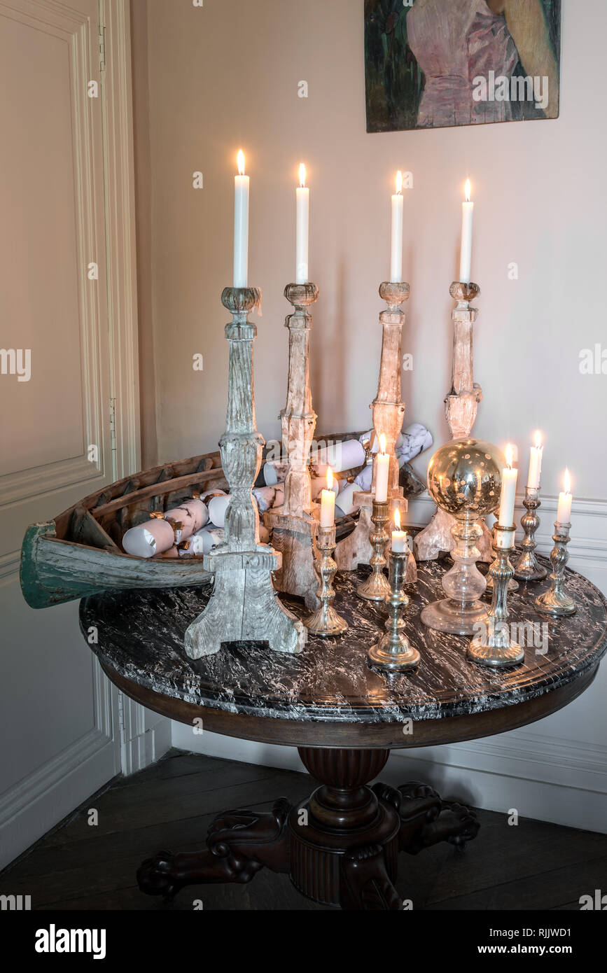 18th century church candlesticks are displayed on an 1840’s marble-topped table Stock Photo