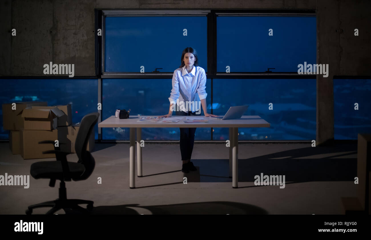 portrait of young female architect on construction site checking documents and business workflow using laptop computer in new startup office Stock Photo