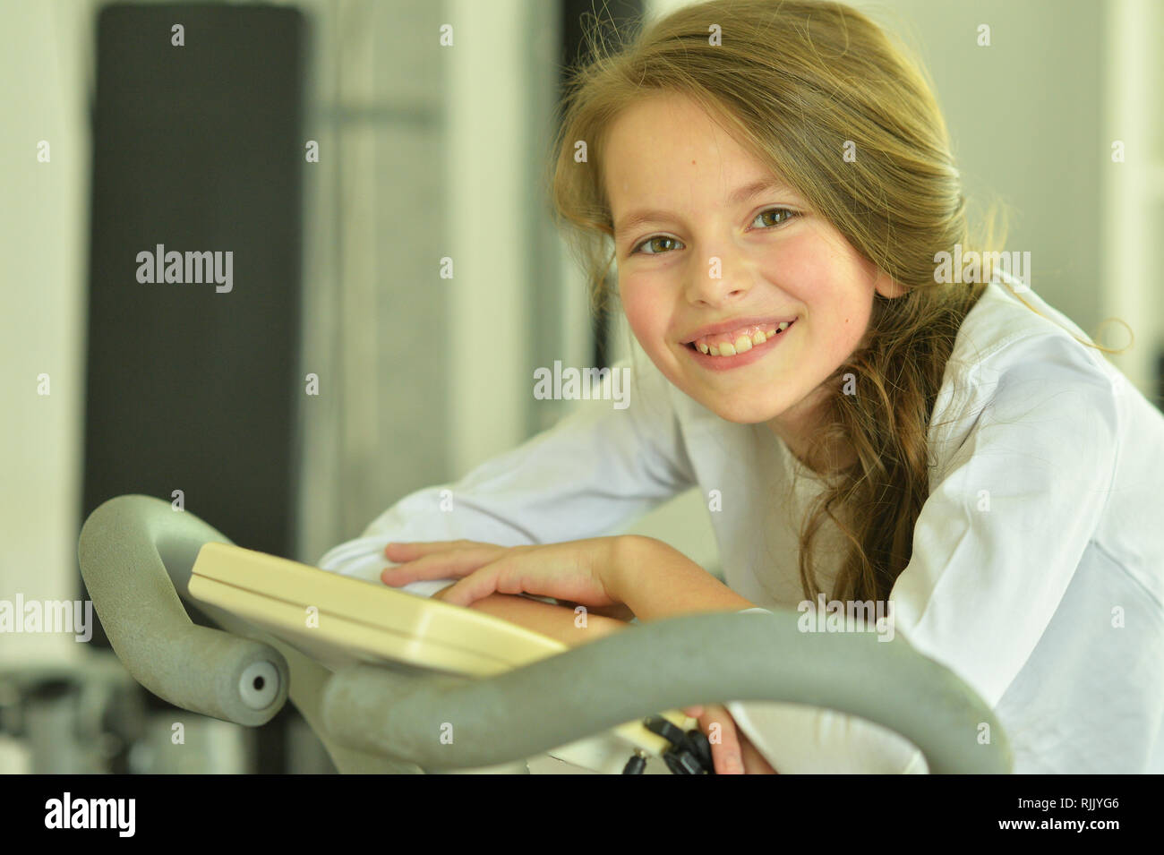 Portrait of cute little girl doing exercises Stock Photo - Alamy