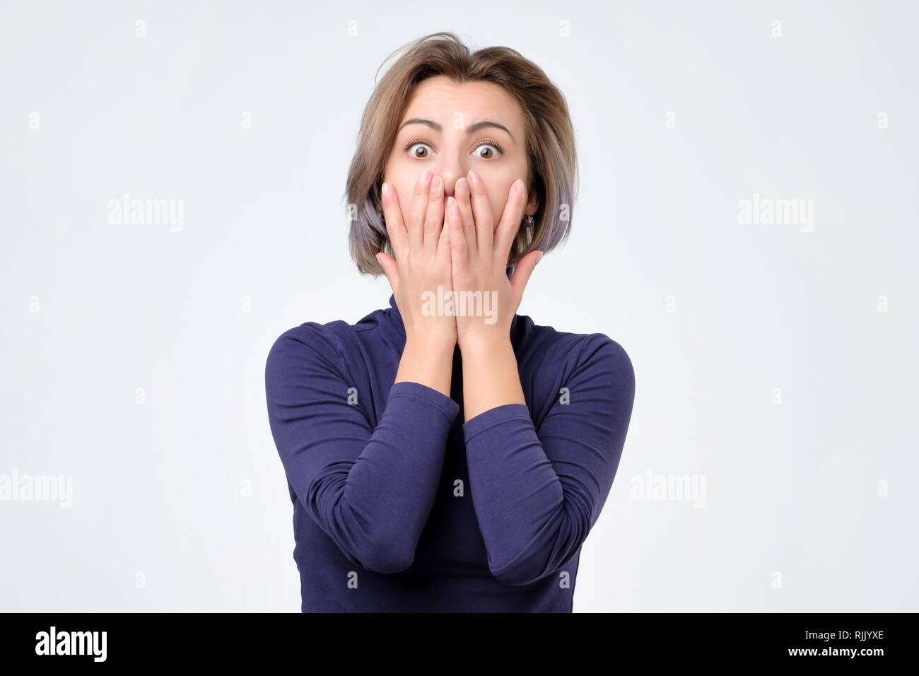 Portrait of amazed young woman over white background Stock Photo - Alamy