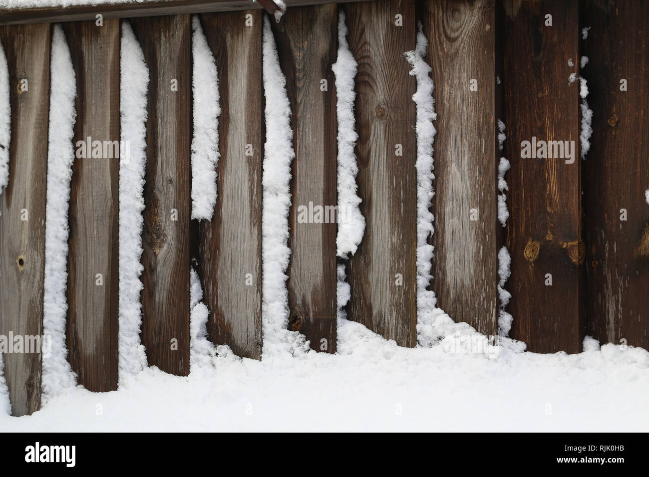 Snow covered tree with wooden fence hi-res stock photography and images ...