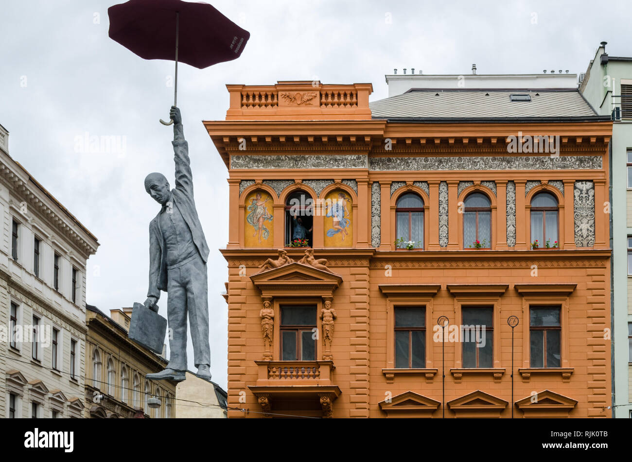 Slight Uncertainty by Michal Trpak, Umbrella Hanging Man, art installation in Prague, Czech Republic Stock Photo