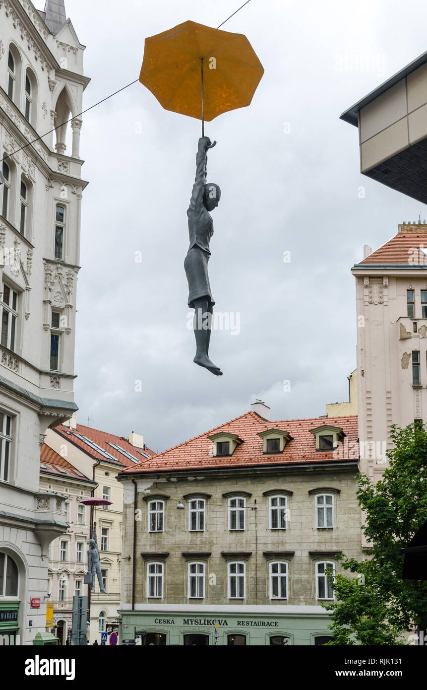 Slight Uncertainty by Michal Trpak, Umbrella Hanging Woman, art installation in Prague, Czech Republic Stock Photo