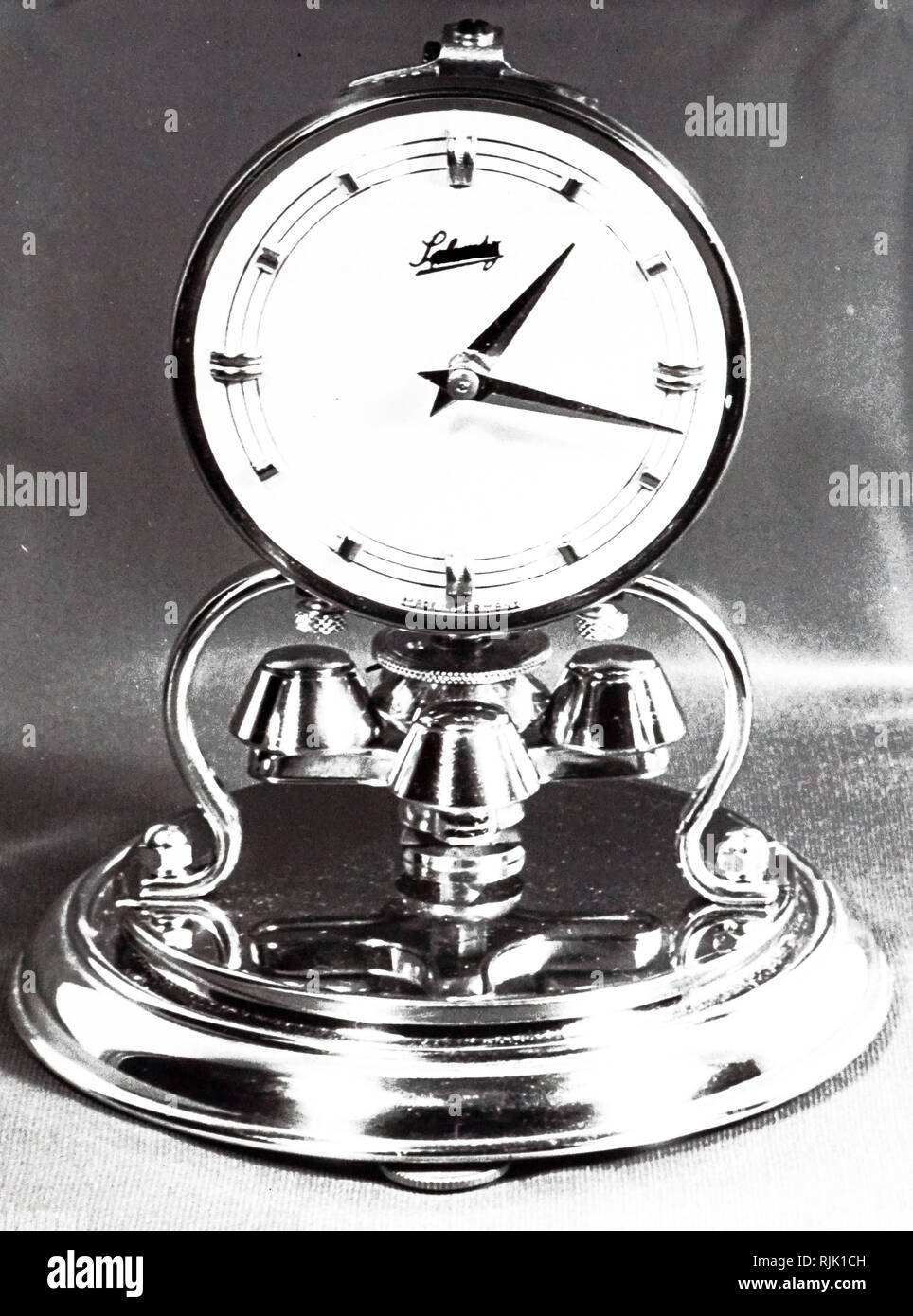 A photograph of a clock with a torsion pendulum. Dated 20th century