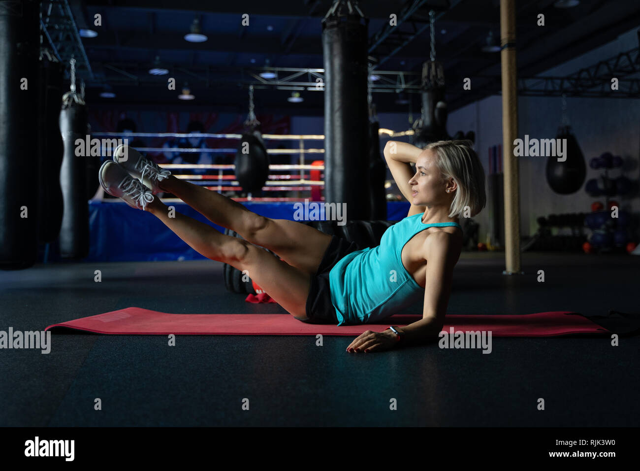 Young attractive cool woman practicing abs exercise, Sit Ups, working ...