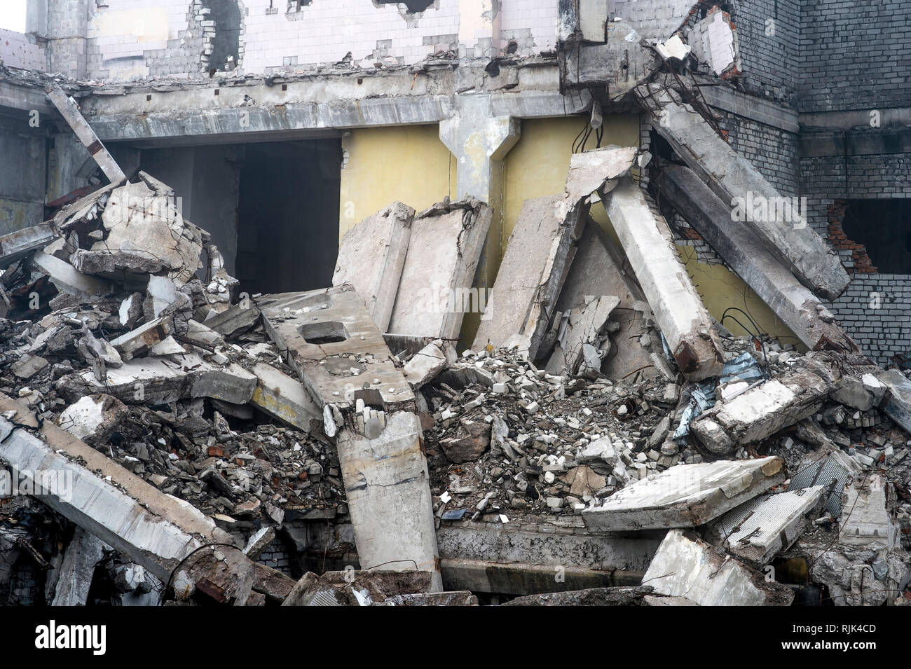 A huge pile of gray concrete debris from piles and stones of the ...