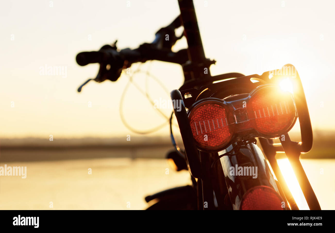 Detail view of a bicycle in a backlit situation, signs of wear show the use on a bicycle tour Stock Photo