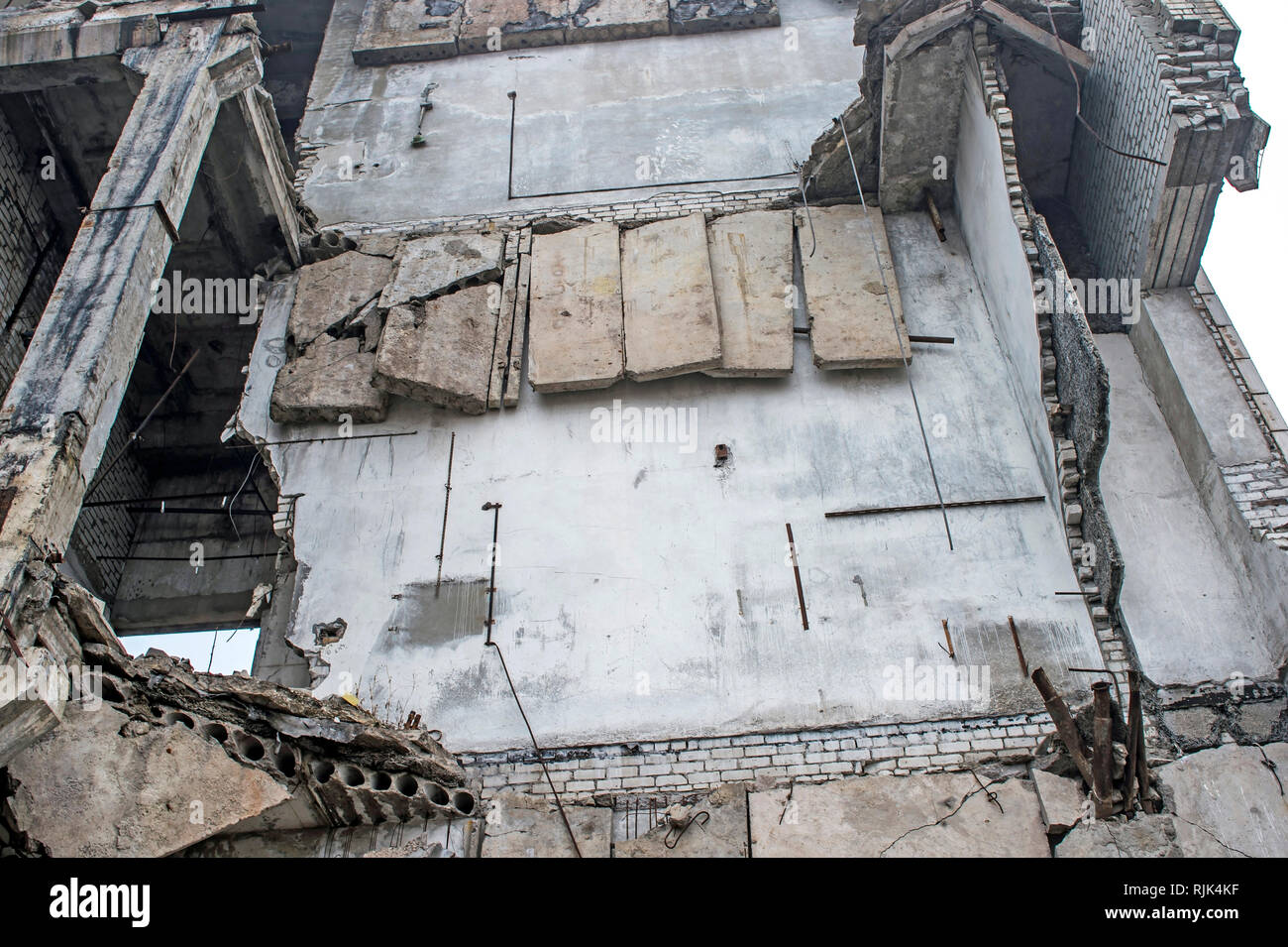 The Concrete Wall Of The Destroyed Large Building With Hanging Concrete Slabs On The Reinforcement Bottom View Background Stock Photo Alamy