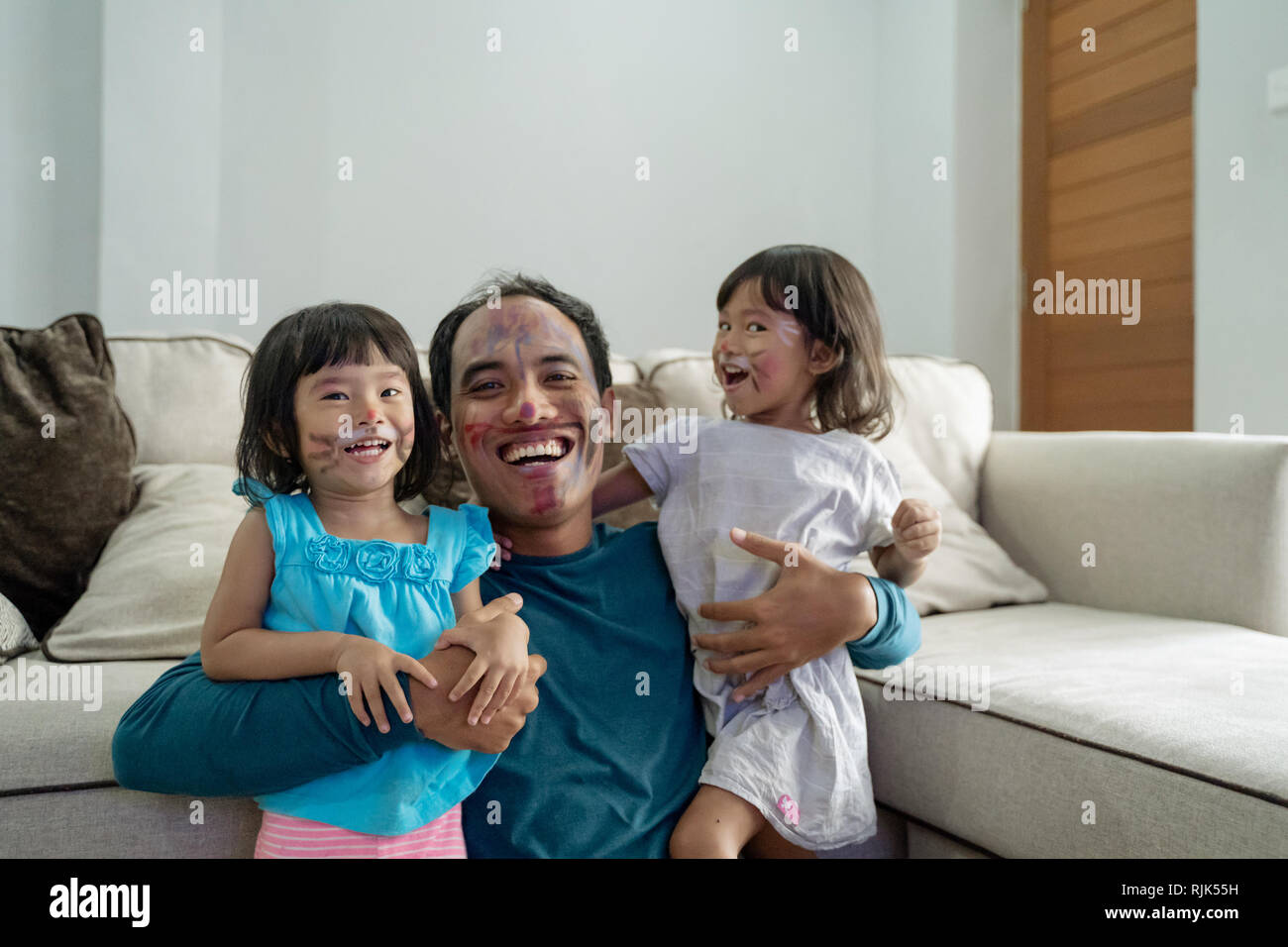 face painting with daddy at home Stock Photo Alamy