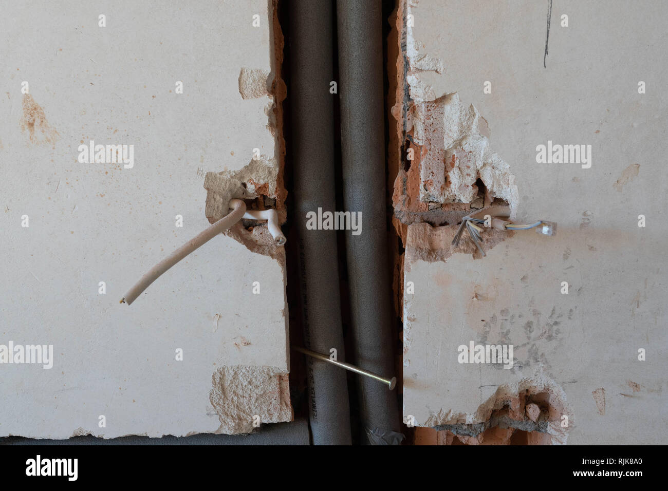 isolated heating pipes in the wall Stock Photo Alamy