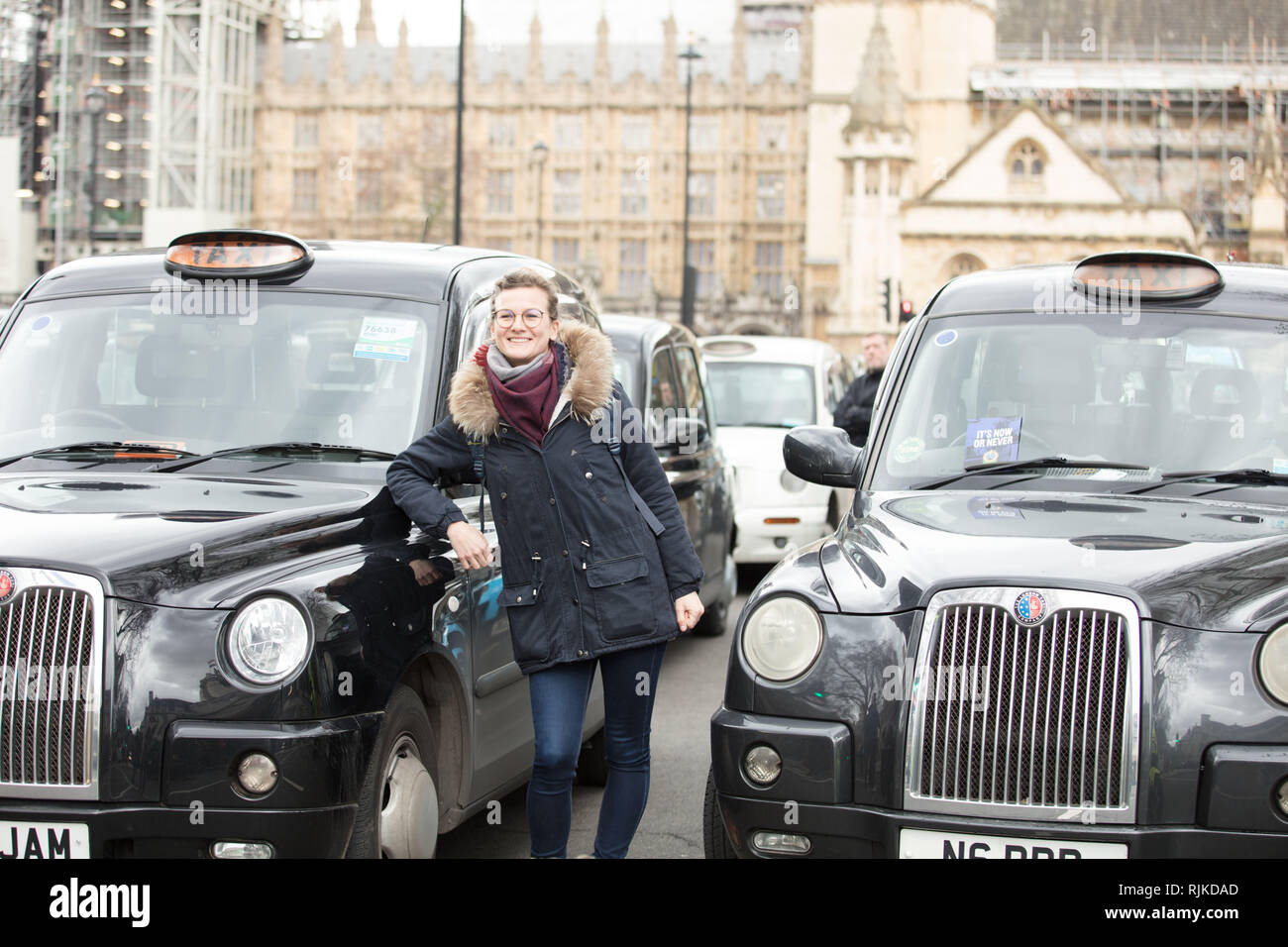 London, UK. 6th February, 2019. Tourist taking a picture during the London cab drivers protest on Parliament Square. Credit: Joe Kuis / Alamy Live News Stock Photo