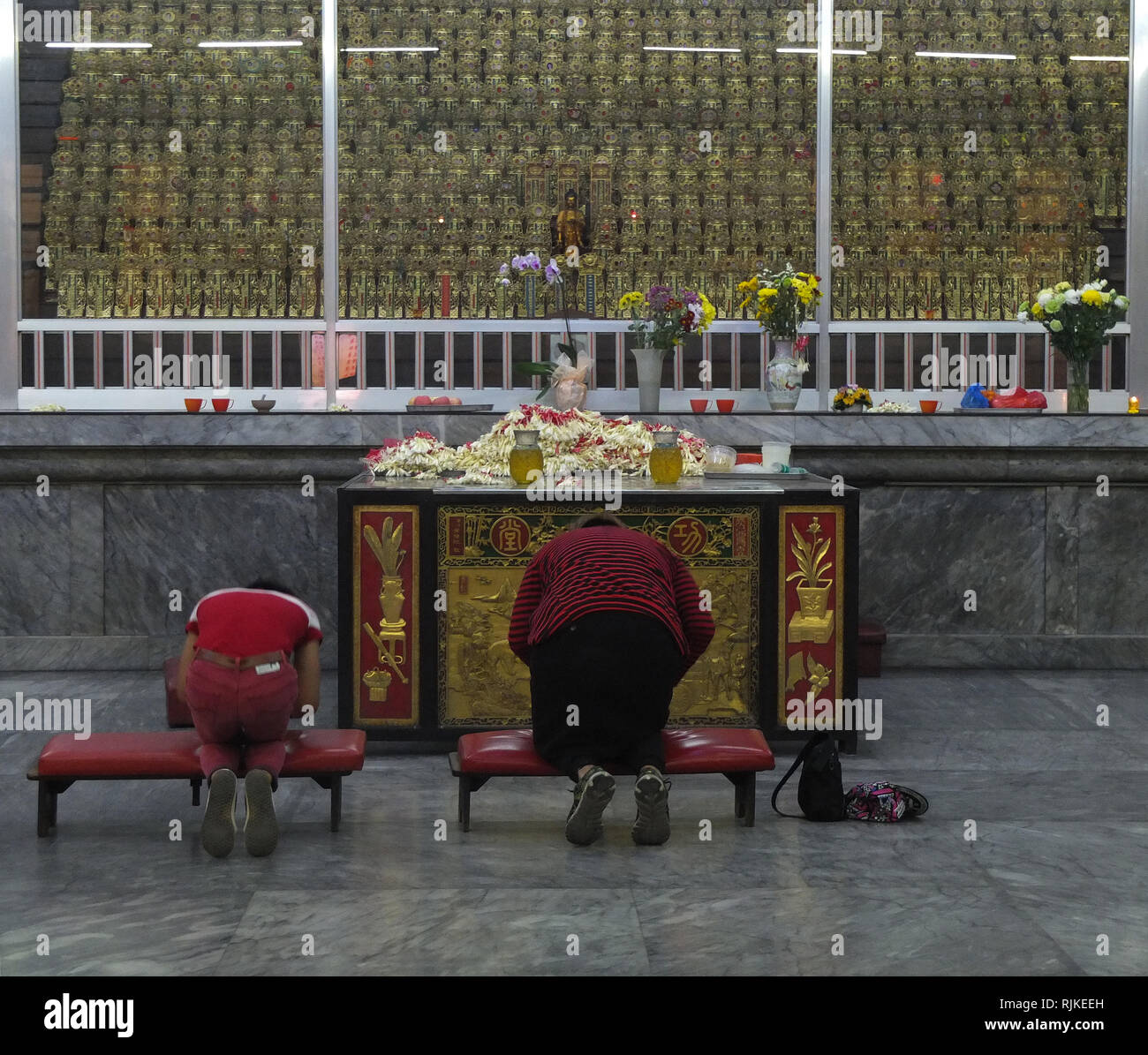 Chinese are seen giving respect to their deceased relatives at the Temple. Senguan Temple in the Philippines is a prominent Buddhist edifice in Manila.  It contains a stupa, a huge repository for urns of human ashes, several meditation rooms, and various shrines. It is a major cultural center for the Chinese Filipino community. Stock Photo