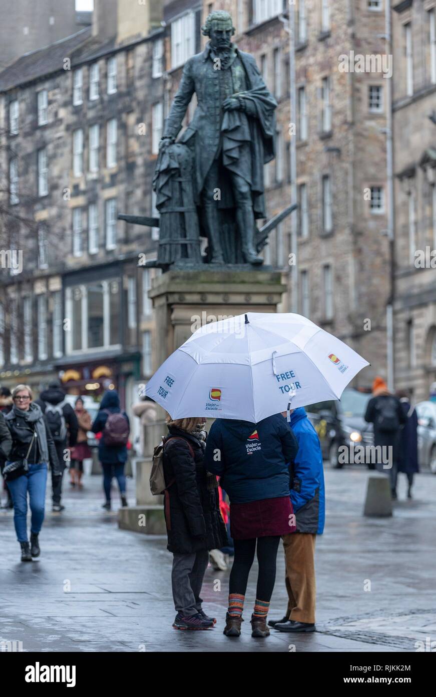 Edinburgh, UK. 07th Feb, 2019. Councillors in Scotland's capital city, Edinburgh, vote on proposals to introduce a tourist tax of £2 per person, per night. The proposals, if approved, will also need legislative change by the Scottish Government which was signalled in the recent Budget. Pictured: One of the many Free Tours sellers on Edinburgh's Royal Mile below a statue of the free-market economist, Adam Smith Credit: Rich Dyson/Alamy Live News Stock Photo