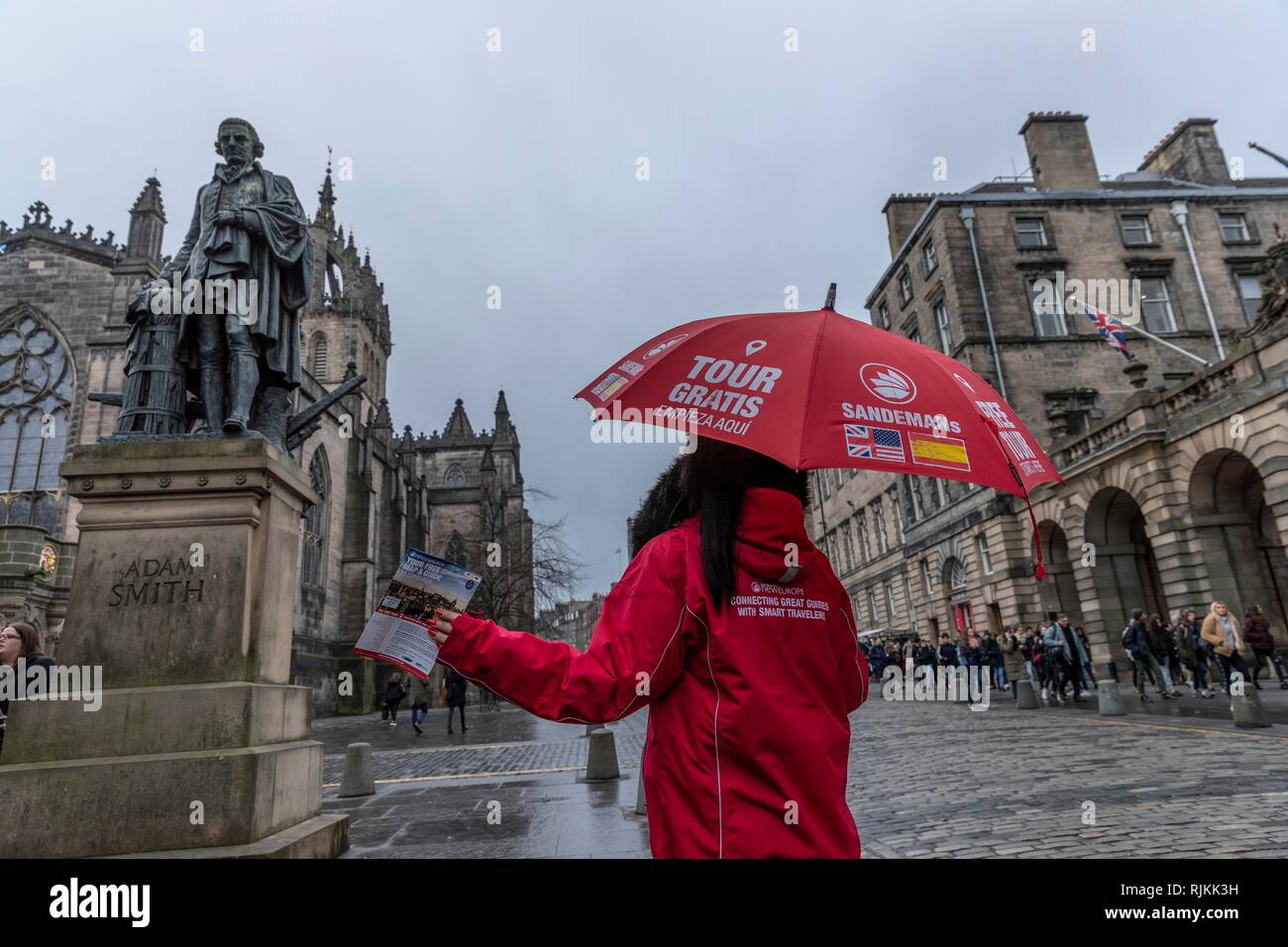 Edinburgh, UK. 07th Feb, 2019. Councillors in Scotland's capital city, Edinburgh, vote on proposals to introduce a tourist tax of £2 per person, per night. The proposals, if approved, will also need legislative change by the Scottish Government which was signalled in the recent Budget. Pictured: One of the many Free Tours sellers on Edinburgh's Royal Mile under a statue of free-market economist, Adam Smith Credit: Rich Dyson/Alamy Live News Stock Photo