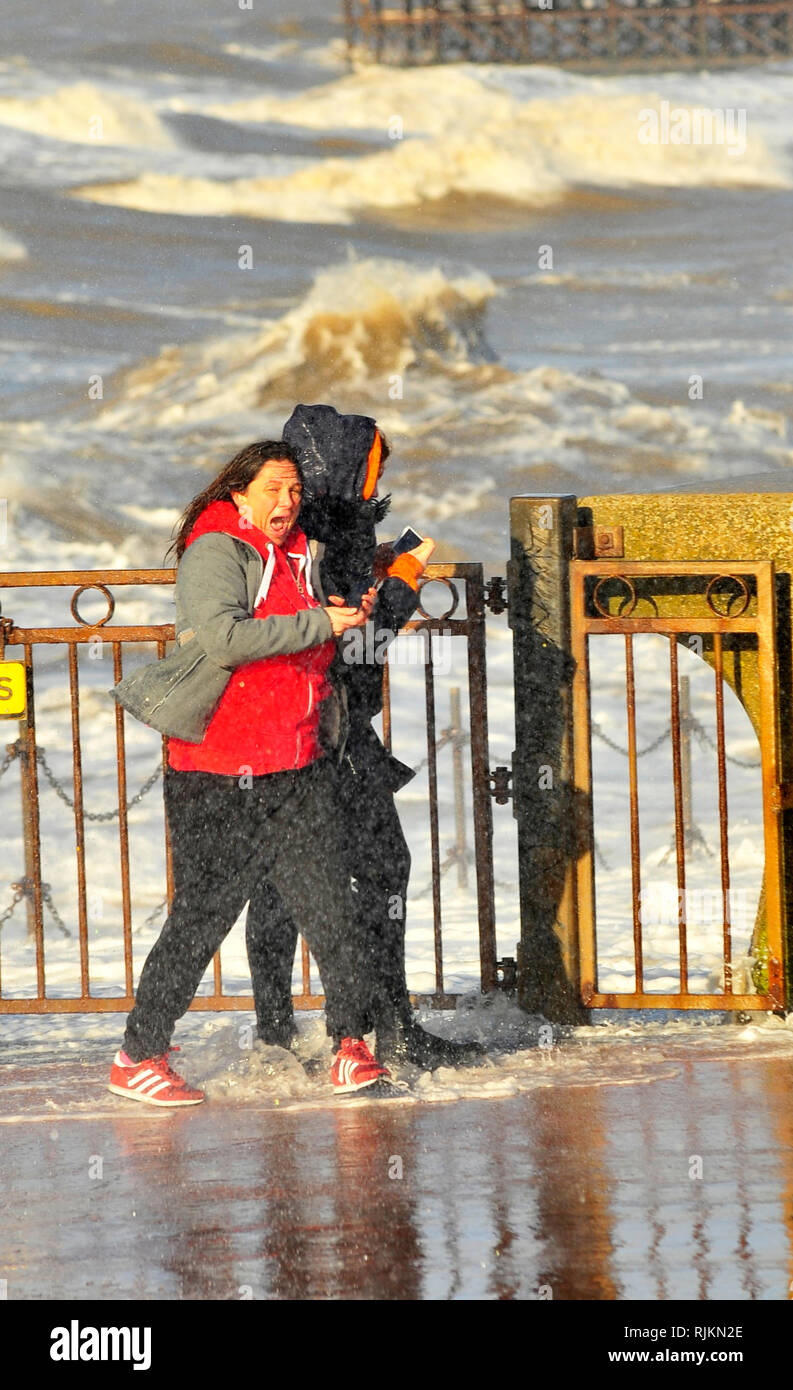 Blackpool, UK. 7th February 2019. A combination of strong winds and a high tide produced spectacular seas at Blackpool. Two young women got too close to the waves with their mobile phones and had to bid a quick retreat after getting a good soaking (3 pics). Kev Walsh/Alamy live news Credit: kevin walsh/Alamy Live News Stock Photo