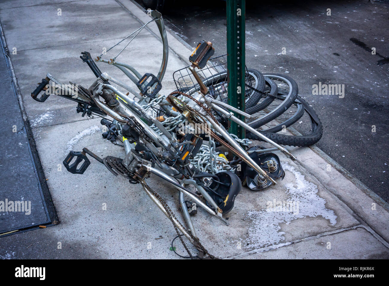 An assortment of derelict and abandoned bicycles chained to a bike rack in the New York neighborhood of Chelsea on Thursday, January 31, 2019. (Â© Richard B. Levine) Stock Photo