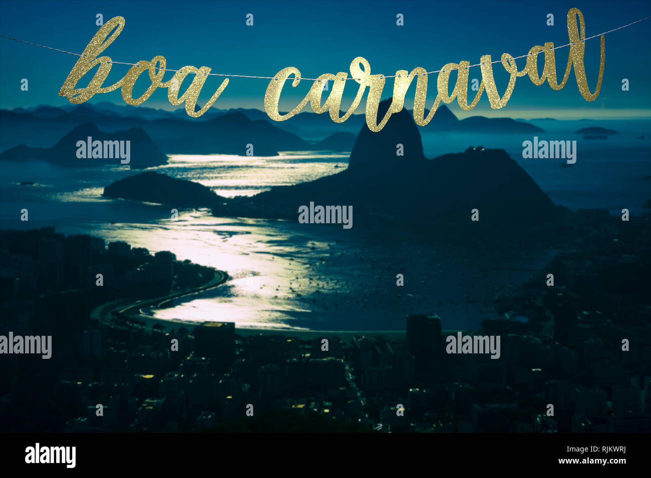 Boa Carnaval (Happy Carnival in Portuguese) gold glitter banner hanging above a moonlit Rio de Janeiro skyline with Sugarloaf Mountain at night Stock Photo
