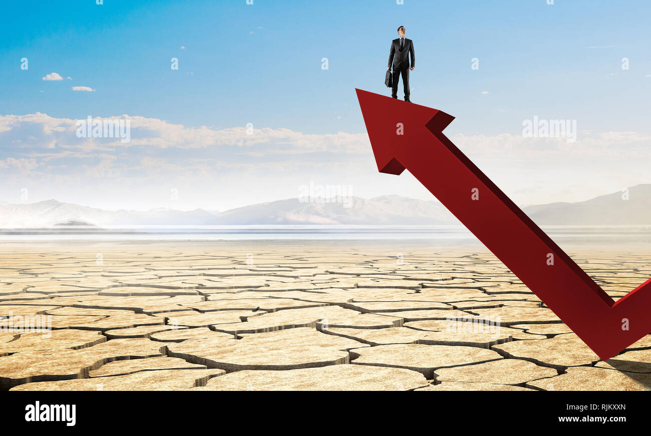 Businessman standing on top of big arrow and looking into the distance ...