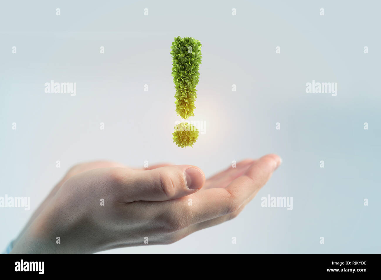 Hand of businessman holding green exclamation mark Stock Photo - Alamy