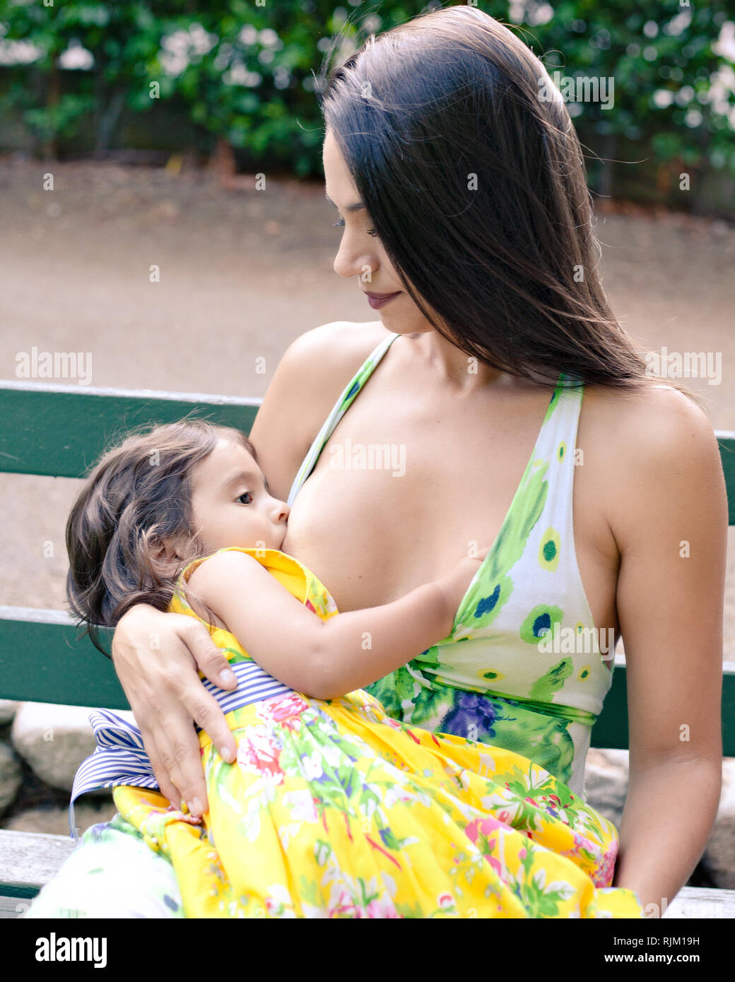 Mother breastfeeding her daughter Stock Photo - Alamy