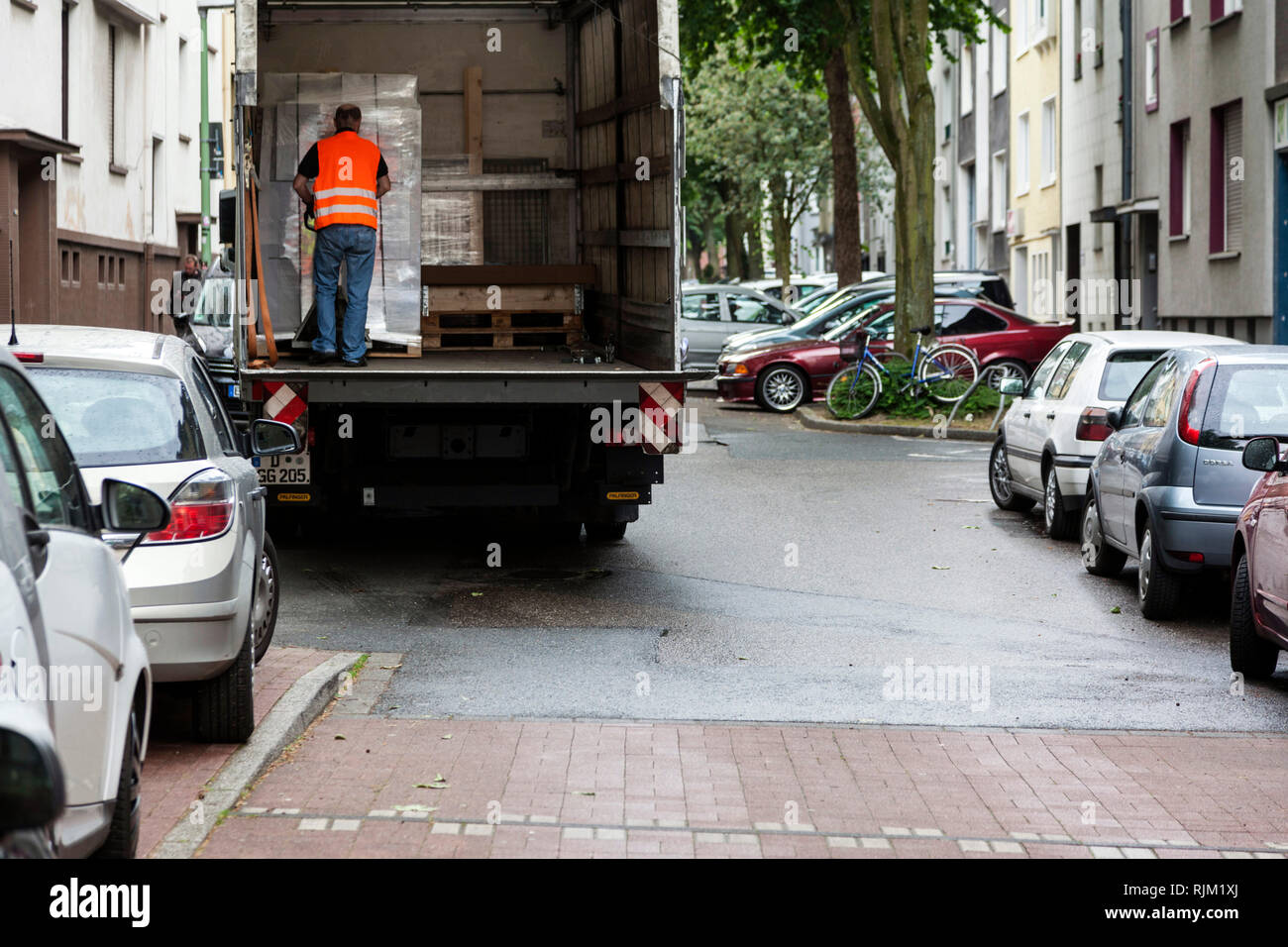Motorist loading and unloading in a residential area Stock Photo