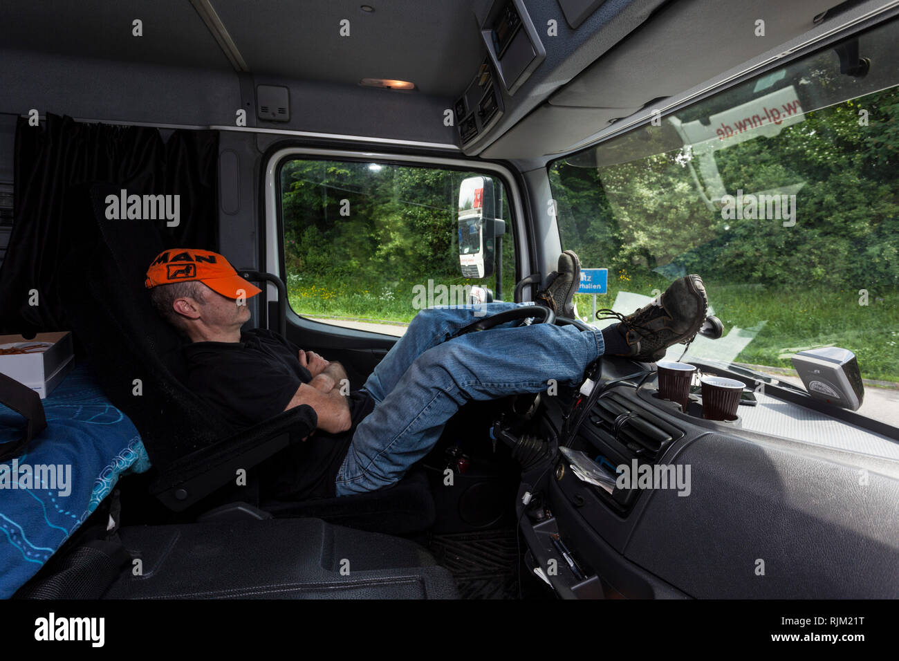 Motorist is sleeping in the cab of his truck Stock Photo