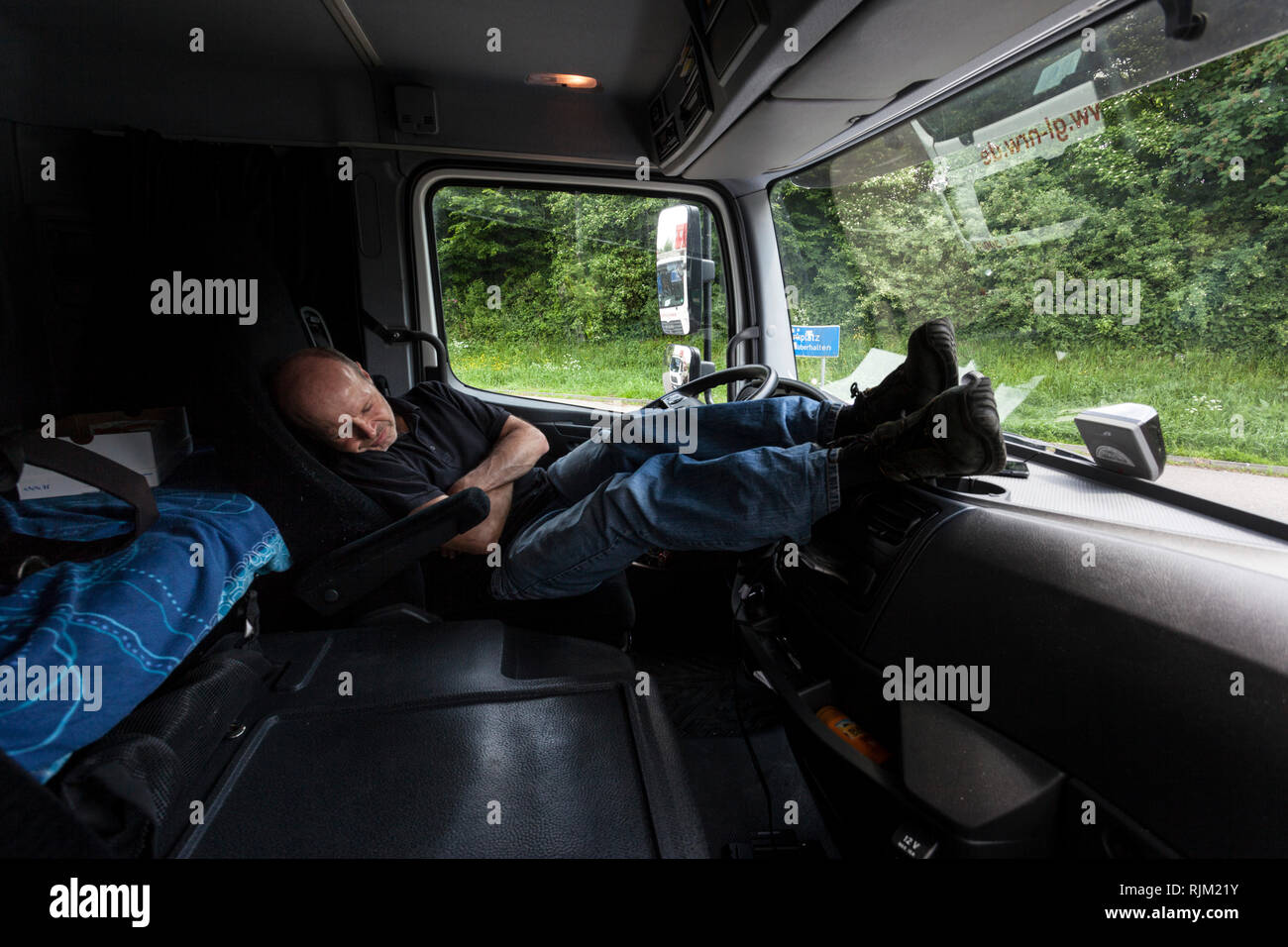 Motorist is sleeping in the cab of his truck Stock Photo