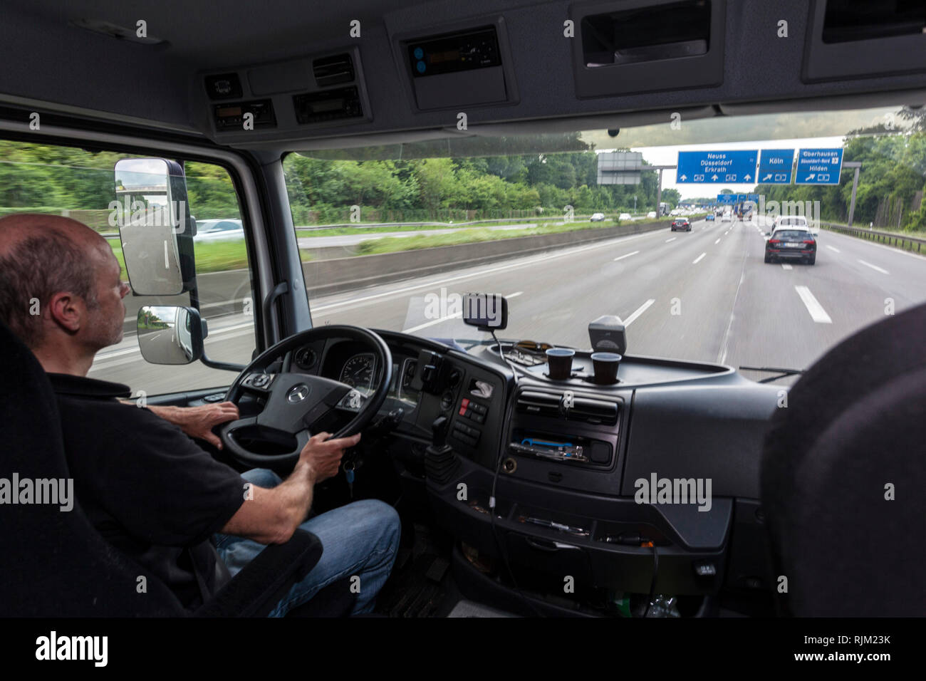 Driver in his truck during his tour Stock Photo