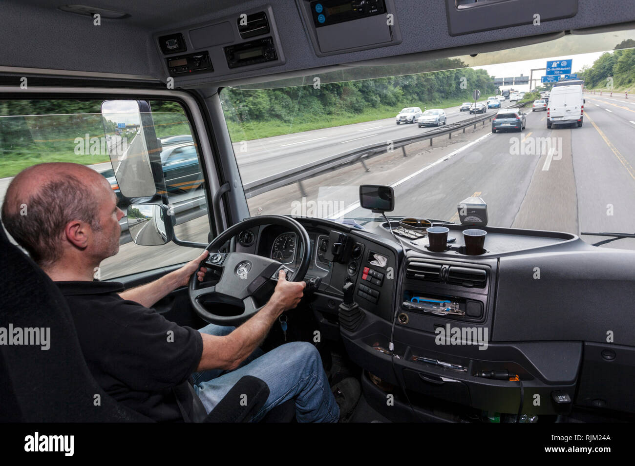 Driver in his truck during his tour Stock Photo