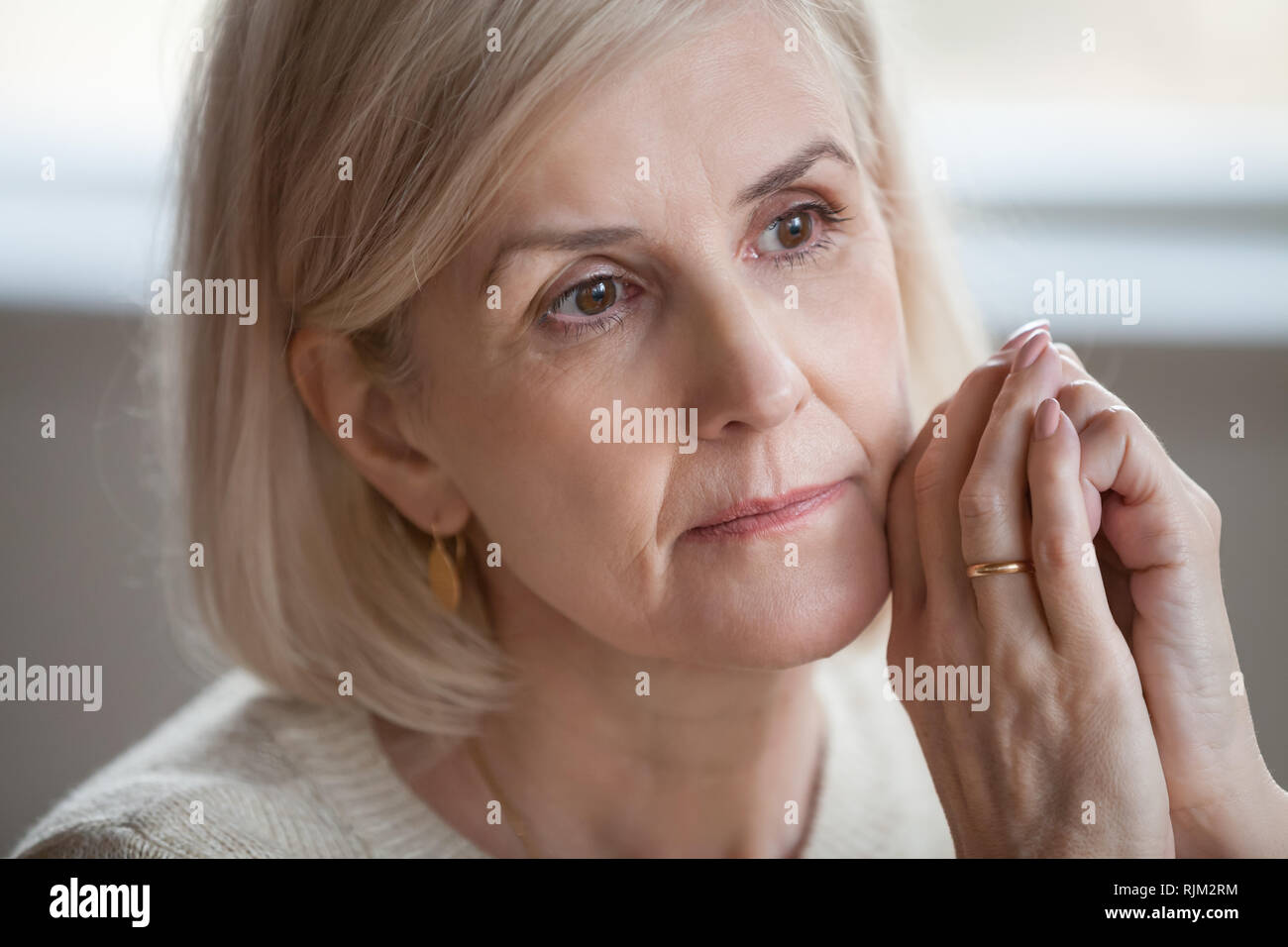 Close up portrait sad thoughtful attractive old woman Stock Photo