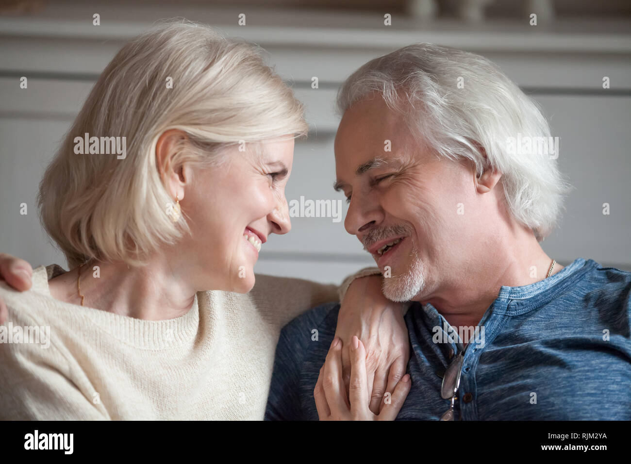 Closeup portrait of aged spouses smiling looking at each other Stock Photo