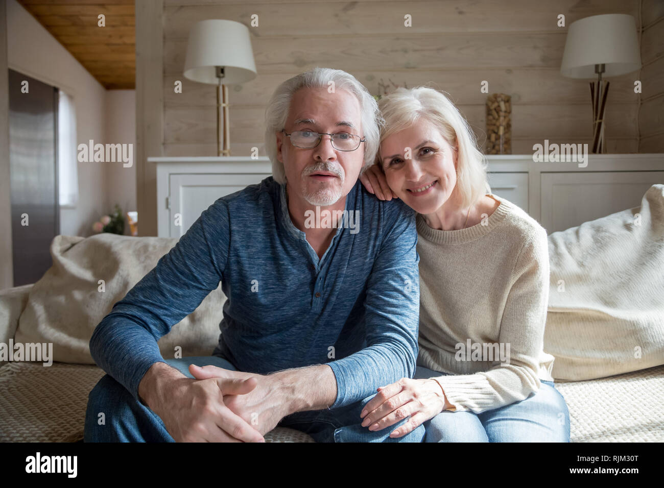 Mature spouses make video call looking at camera Stock Photo