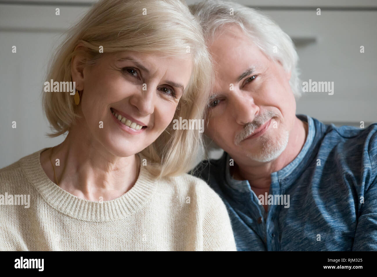 Close up portrait of aged couple smiling looking at camera Stock Photo