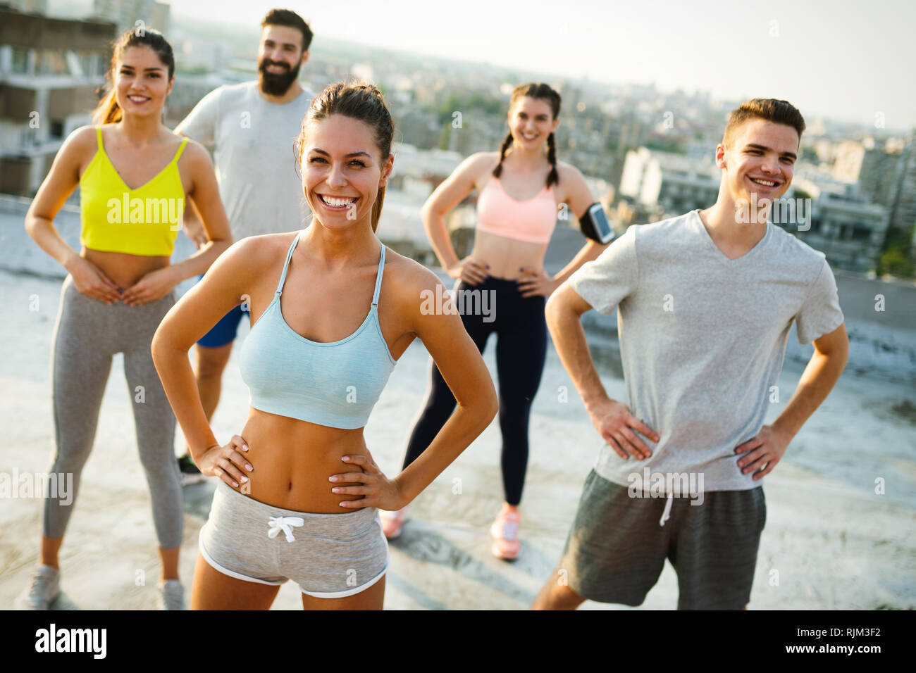 Fitness, sport, friendship and healthy lifestyle concept . Group of happy people exercising Stock Photo