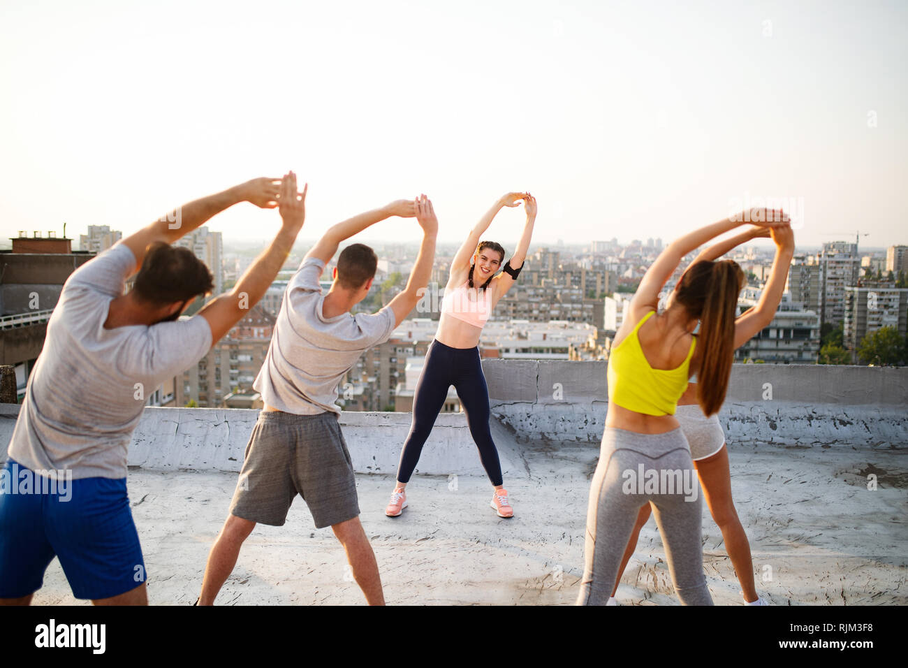 Fitness, sport, friendship and healthy lifestyle concept . Group of happy people exercising Stock Photo