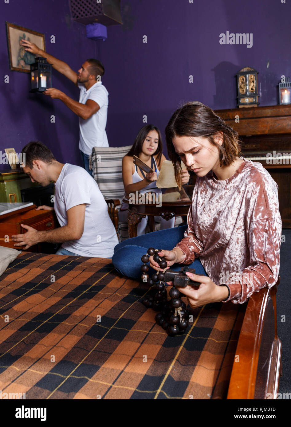 Young People Looking At Old Wooden Rosary While Pursuing