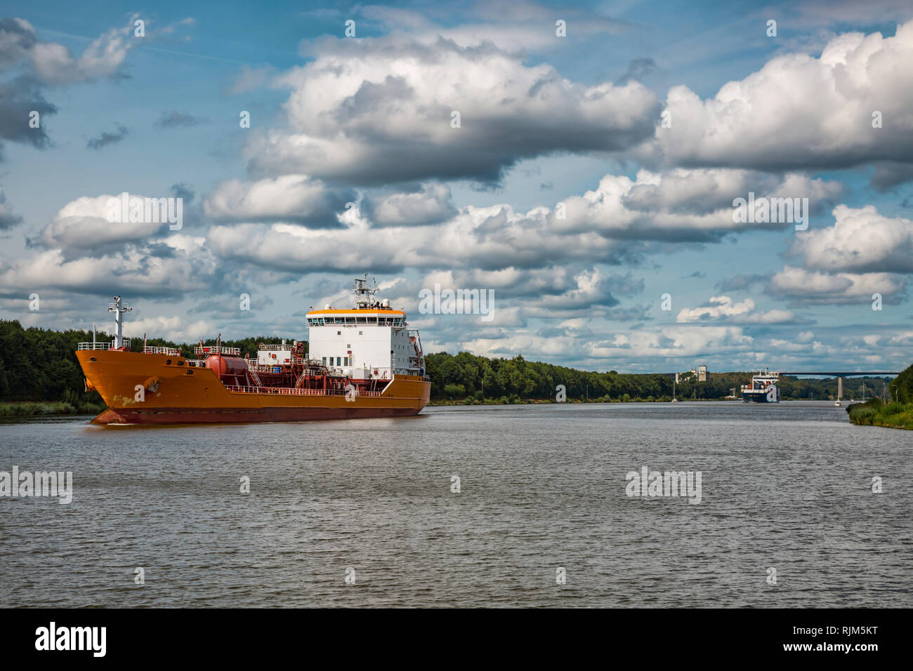 Orange transport ship on the Kiel canal Stock Photo