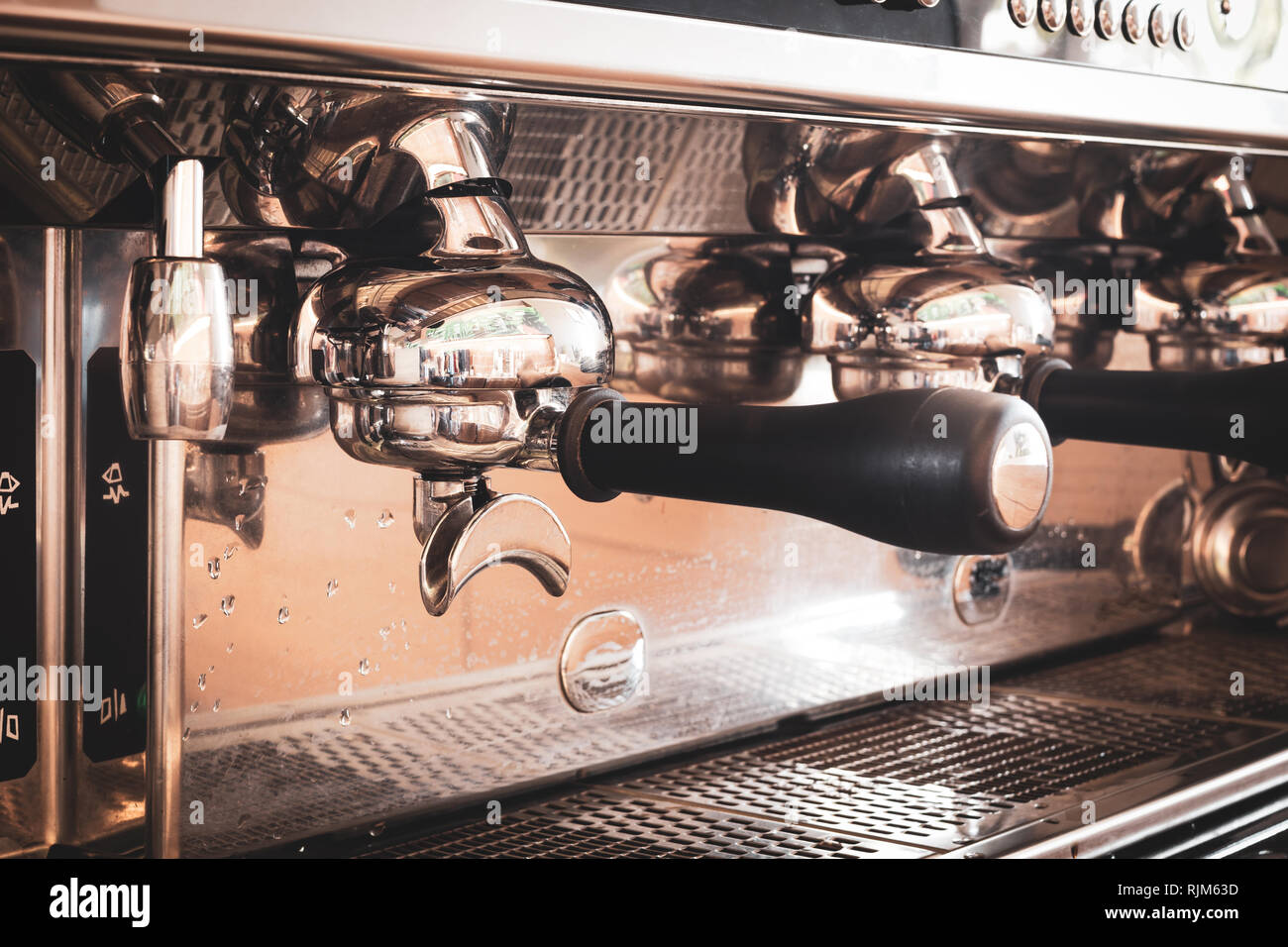 Close up bottomless portafilter of coffee machine. Stock Photo