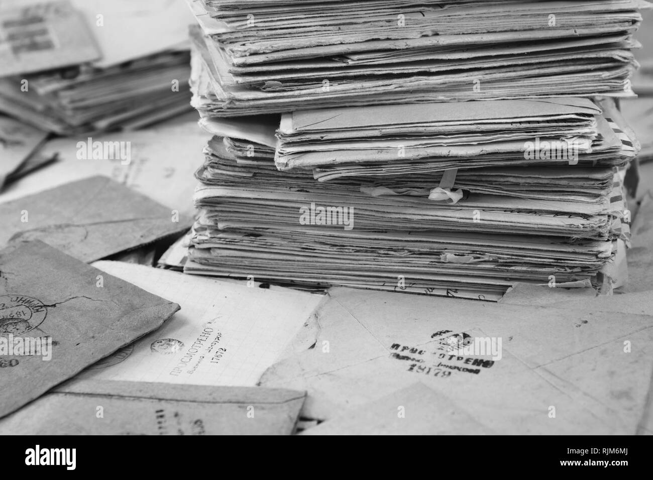 Pile of the old postal paper mails of 20 century in USSR. Envelopes are stamped: 'Viewed by military cencorship'. Black and white Stock Photo