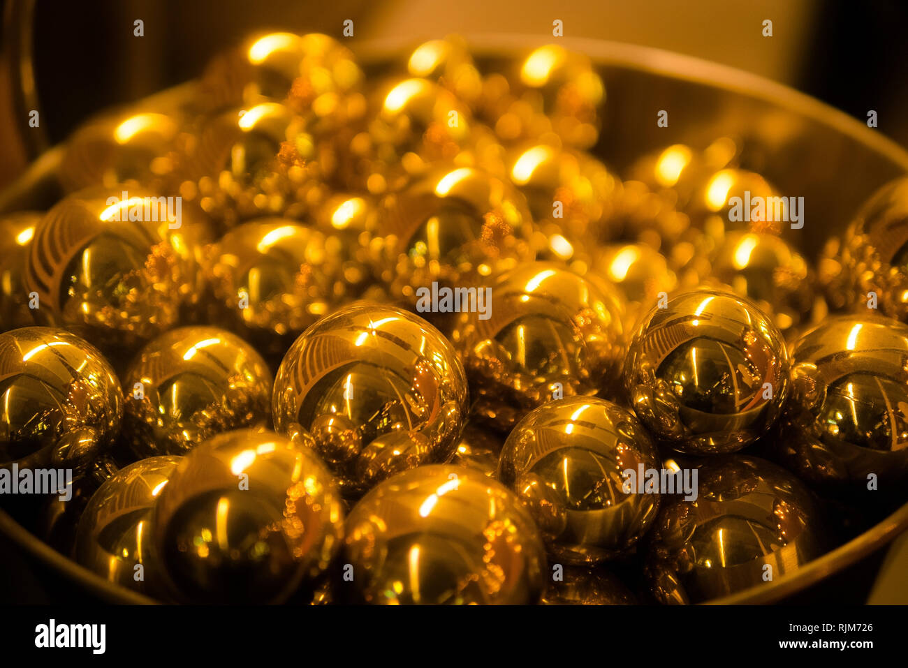 Pile of golden sphere balls. Close up, shallow depth of field Stock