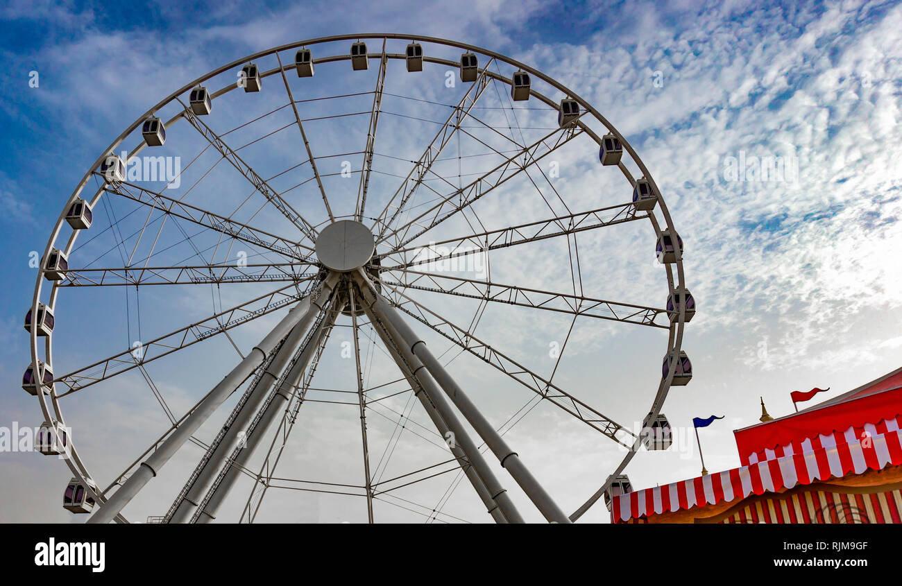 Big wheel at a fair festival with blue sky Stock Photo