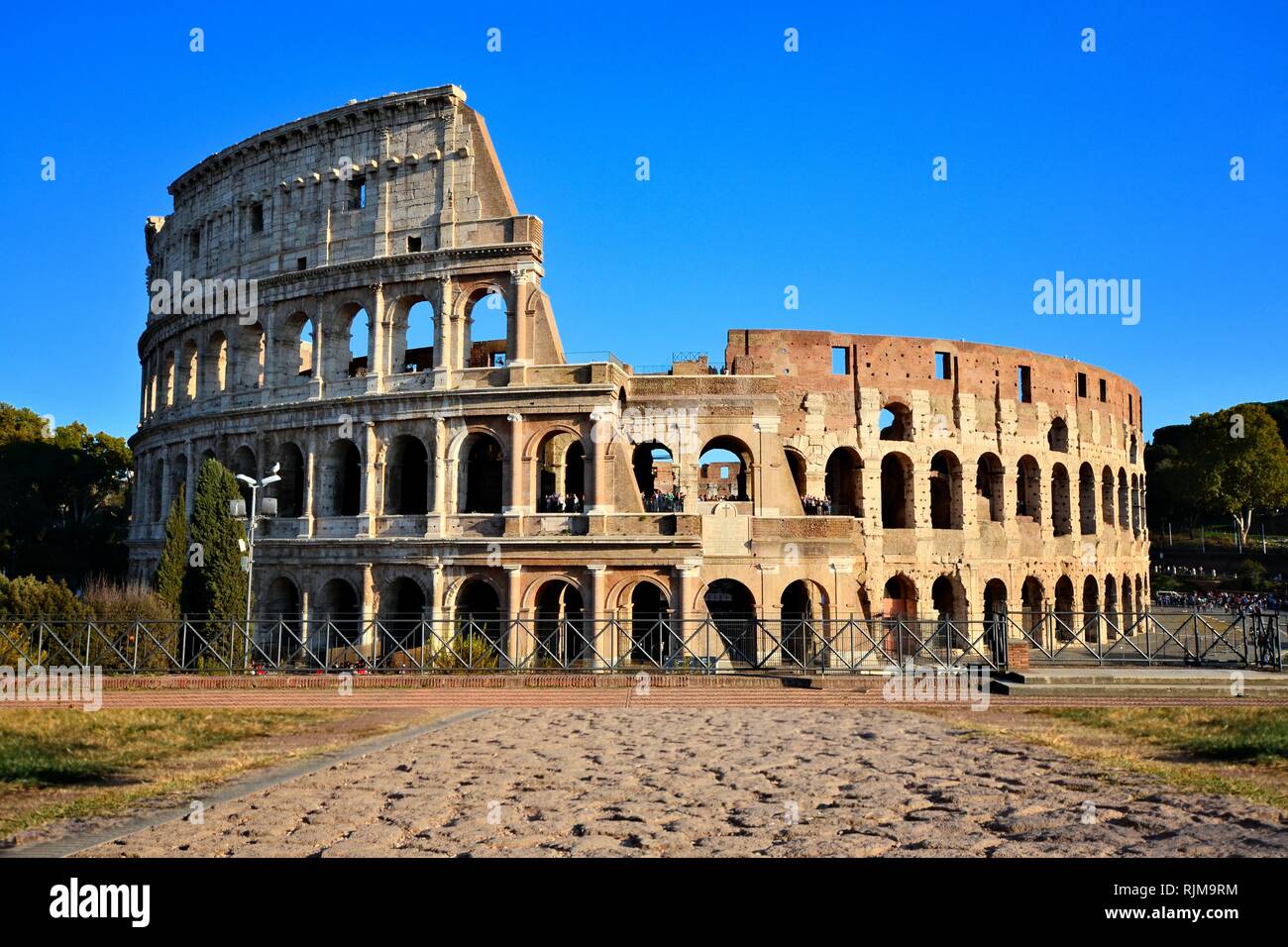 Rome, Italy, the Coliseum. View from Forum with ancient stone road. Stock Photo