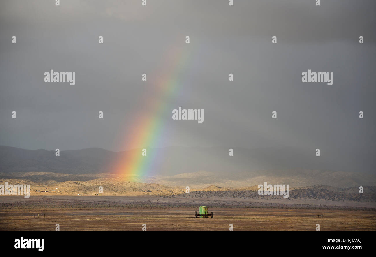 A spring storm creates a rainbow over the San Andreas fault in Carrizo Plain national monument, California. Stock Photo